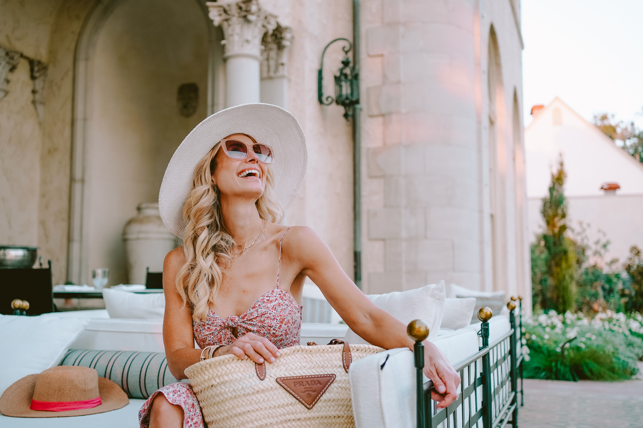 girl in floral dress and hat with Gucci bag