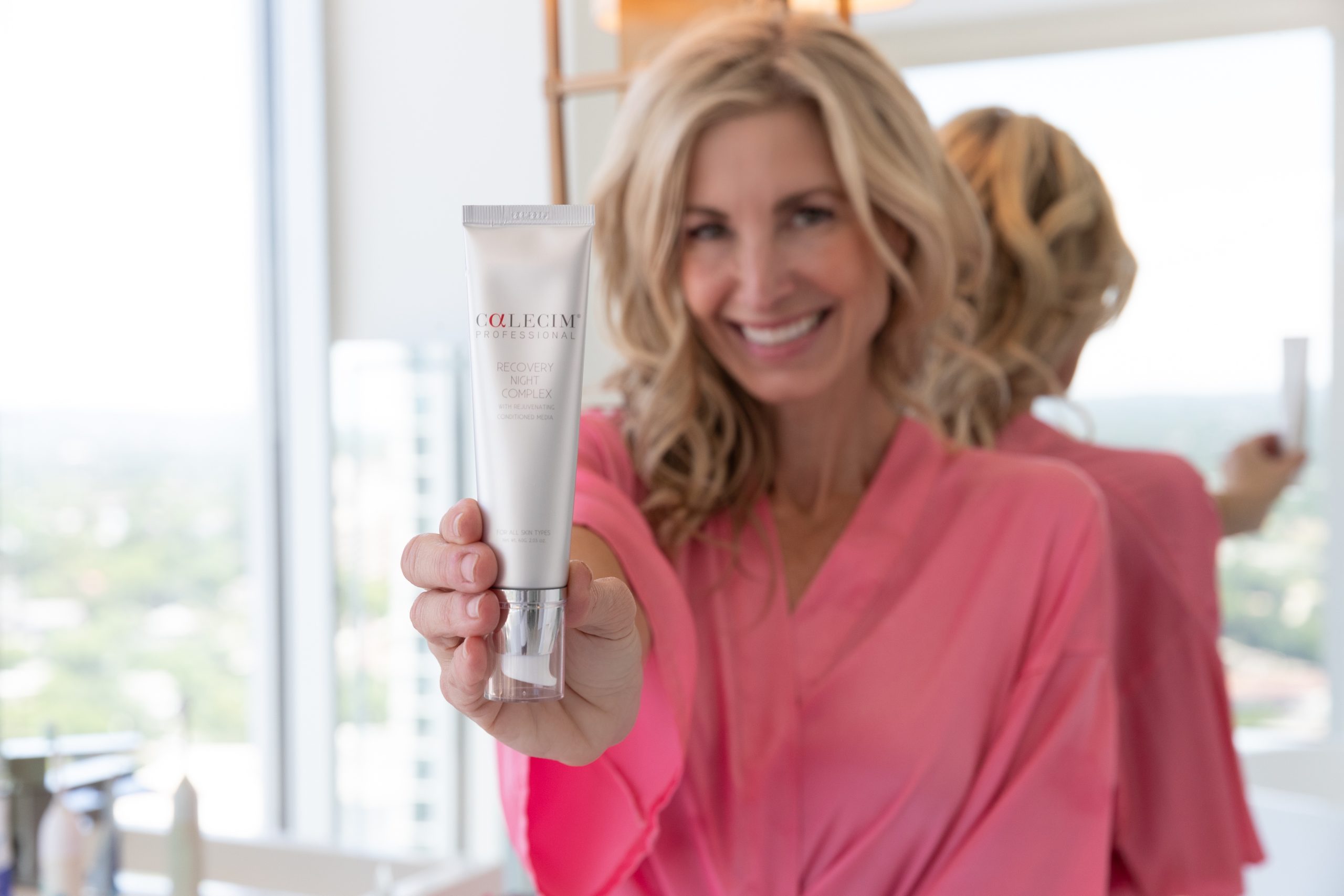 woman holding stem cell moisturizer 